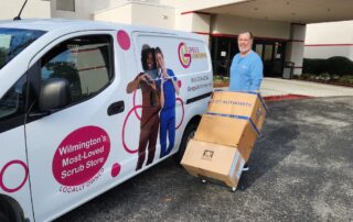 Greg's Uniforms van delivering a scrub order to a large office in Wilmington. Keeping it local helps your community.